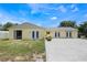 The backyard features a well-manicured lawn and exterior access to multiple rooms at 7750 Murcott Cir, Orlando, FL 32835
