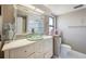 This bathroom features a vanity with vessel sink, decorative mirror, and ample storage space at 7750 Murcott Cir, Orlando, FL 32835