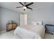 This bedroom features a ceiling fan, hardwood floors, and a comfortable bed with decorative pillows at 7750 Murcott Cir, Orlando, FL 32835