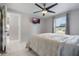 This bedroom features a ceiling fan and TV and is conveniently located near a full bathroom at 7750 Murcott Cir, Orlando, FL 32835
