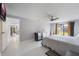 Bright bedroom featuring neutral decor, a ceiling fan, and sliding glass doors to the backyard at 7750 Murcott Cir, Orlando, FL 32835