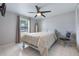This bedroom has bright lighting, a ceiling fan, and neutral decor at 7750 Murcott Cir, Orlando, FL 32835