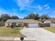 Charming single-story home with a well-manicured lawn and a two-car garage at 7750 Murcott Cir, Orlando, FL 32835