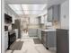 Functional kitchen featuring stainless steel appliances, light gray cabinetry, and tile flooring at 7750 Murcott Cir, Orlando, FL 32835