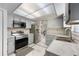 Well-lit kitchen with stainless steel appliances, gray cabinetry, and a practical layout at 7750 Murcott Cir, Orlando, FL 32835