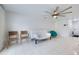 Comfortable living area with tiled floors, a ceiling fan, and a minimalist design at 7750 Murcott Cir, Orlando, FL 32835