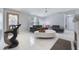 Inviting living room showcasing a white tile floor, modern furniture, and ample natural light at 7750 Murcott Cir, Orlando, FL 32835