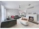 Bright living room featuring a decorative fireplace, modern furniture, and white tile floors at 7750 Murcott Cir, Orlando, FL 32835