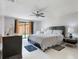 Cozy main bedroom with tiled flooring, a ceiling fan, and a sliding glass door at 7750 Murcott Cir, Orlando, FL 32835