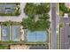 Aerial view featuring a tennis court and parking amidst lush trees in a well-planned neighborhood at 8801 Crayson Ct, Kissimmee, FL 34747