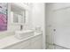 Bright bathroom with large vanity and decorative sink, and a door to the shower area at 8801 Crayson Ct, Kissimmee, FL 34747