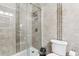 Bathroom featuring a tiled shower with a glass door and a modern toilet and fixtures at 8801 Crayson Ct, Kissimmee, FL 34747