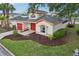 Beautiful home showcases lush landscaping, paired with stylish architecture, and a contrasting dark roof, creating a striking curb appeal at 8801 Crayson Ct, Kissimmee, FL 34747