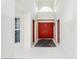 Bright foyer with red double doors and a transom window, offering a welcoming and grand entrance to the home at 8801 Crayson Ct, Kissimmee, FL 34747