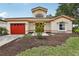 Charming single-Gathering home with a well-manicured lawn, and a vibrant red garage door, offering an inviting curb appeal at 8801 Crayson Ct, Kissimmee, FL 34747