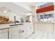 Bright kitchen area with white cabinets, granite countertops, and stainless dishwasher at 8801 Crayson Ct, Kissimmee, FL 34747