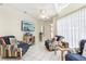 Bright living room with tile flooring, ceiling fan, and comfortable seating, creating a welcoming space for relaxation and socializing at 8801 Crayson Ct, Kissimmee, FL 34747