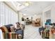 Open-concept living area with tile flooring, ceiling fans, and an adjoining dining area, ideal for relaxed living and entertaining at 8801 Crayson Ct, Kissimmee, FL 34747