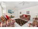Spacious living area featuring comfortable sofas, a decorative rug, and a wall-mounted TV, perfect for Gathering time and relaxation at 8801 Crayson Ct, Kissimmee, FL 34747
