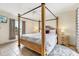 Spacious main bedroom with a four poster bed, ceiling fan, and tile flooring at 8801 Crayson Ct, Kissimmee, FL 34747