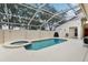 Enclosed pool area featuring a refreshing pool and a built-in spa for ultimate relaxation and privacy at 8801 Crayson Ct, Kissimmee, FL 34747