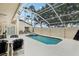 Enclosed pool area with a pool, spa and a table with four chairs, offering a relaxing space at 8801 Crayson Ct, Kissimmee, FL 34747