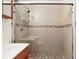 Bathroom shower with decorative tilework, glass enclosure, and a mounted showerhead at 8801 Crayson Ct, Kissimmee, FL 34747