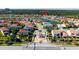 Bird's eye view of the neighborhood showcasing lake views and lush greenery, creating an appealing and tranquil living environment at 10427 Royal Cypress Way, Orlando, FL 32836