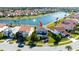 Aerial shot showcases this two-story home's backyard and pond, nestled within a serene community with lush landscaping at 10427 Royal Cypress Way, Orlando, FL 32836