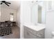 Bright bathroom adjacent to a workspace, featuring a vanity with light countertop at 10427 Royal Cypress Way, Orlando, FL 32836