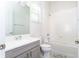 Clean bathroom featuring a tub, shower, toilet and grey vanity with white countertop at 10427 Royal Cypress Way, Orlando, FL 32836