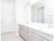 Bathroom with dual sinks, gray cabinets, and modern fixtures at 10427 Royal Cypress Way, Orlando, FL 32836