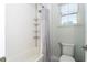 Bathroom with a shower and toilet with white tile at 10427 Royal Cypress Way, Orlando, FL 32836