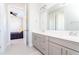 Bathroom with dual sinks, gray cabinets, and neutral tones at 10427 Royal Cypress Way, Orlando, FL 32836
