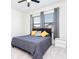 Bedroom with a bed, windows, and fan at 10427 Royal Cypress Way, Orlando, FL 32836