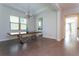 Elegant dining room with modern table, chandelier, and ample natural light at 10427 Royal Cypress Way, Orlando, FL 32836