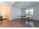Large dining room featuring modern furniture, light hardwood floors, and plenty of natural light at 10427 Royal Cypress Way, Orlando, FL 32836