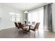 Elegant dining room featuring a modern table with seating for six, large windows, and neutral decor at 10427 Royal Cypress Way, Orlando, FL 32836
