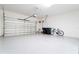 Bright and spacious garage featuring epoxy flooring and ample space for storage and vehicles at 10427 Royal Cypress Way, Orlando, FL 32836
