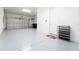 Spacious garage with epoxy flooring, overhead door, and ample storage, perfect for vehicles and hobbies at 10427 Royal Cypress Way, Orlando, FL 32836