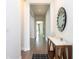 Bright hallway featuring hardwood floors, a stylish mirror, and a marble-topped console table at 10427 Royal Cypress Way, Orlando, FL 32836
