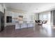 Open concept kitchen with white cabinets, stainless appliances, a center island, and adjacent dining area at 10427 Royal Cypress Way, Orlando, FL 32836