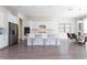 Bright, open kitchen boasts white cabinetry, stainless appliances, a center island with seating, and sleek gray flooring at 10427 Royal Cypress Way, Orlando, FL 32836