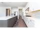 Spacious kitchen with white upper cabinets, gray lower cabinets, stainless appliances, and a large island with seating at 10427 Royal Cypress Way, Orlando, FL 32836