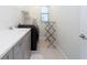 Functional laundry room with washer, dryer, sink, gray cabinets, and folding area at 10427 Royal Cypress Way, Orlando, FL 32836