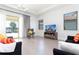 Cozy living room with a television, modern furniture, neutral tones, and a view of the backyard at 10427 Royal Cypress Way, Orlando, FL 32836
