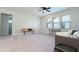 Bright living room featuring neutral walls, carpet, ceiling fan, and lots of natural light from the large windows at 10427 Royal Cypress Way, Orlando, FL 32836