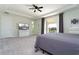 Comfortable main bedroom featuring neutral walls, carpet flooring, and an entertainment center at 10427 Royal Cypress Way, Orlando, FL 32836