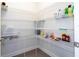 Well-organized pantry with metal shelving, providing ample storage space at 10427 Royal Cypress Way, Orlando, FL 32836