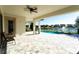 An expansive covered patio offers views of the pool and beautiful lake, perfect for outdoor entertaining at 10427 Royal Cypress Way, Orlando, FL 32836